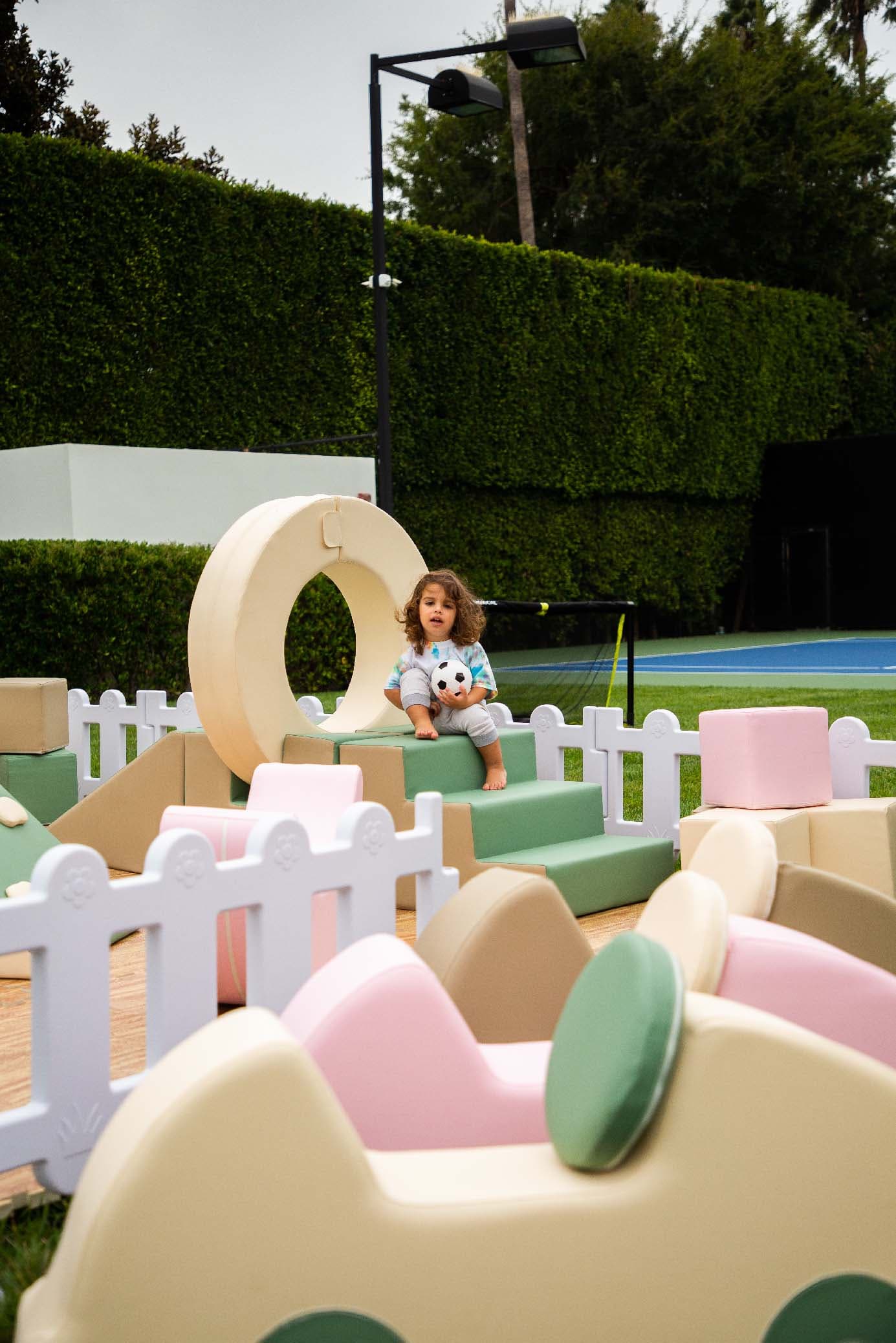 A young child playing in an LA Sports World soft-play setup at a private event