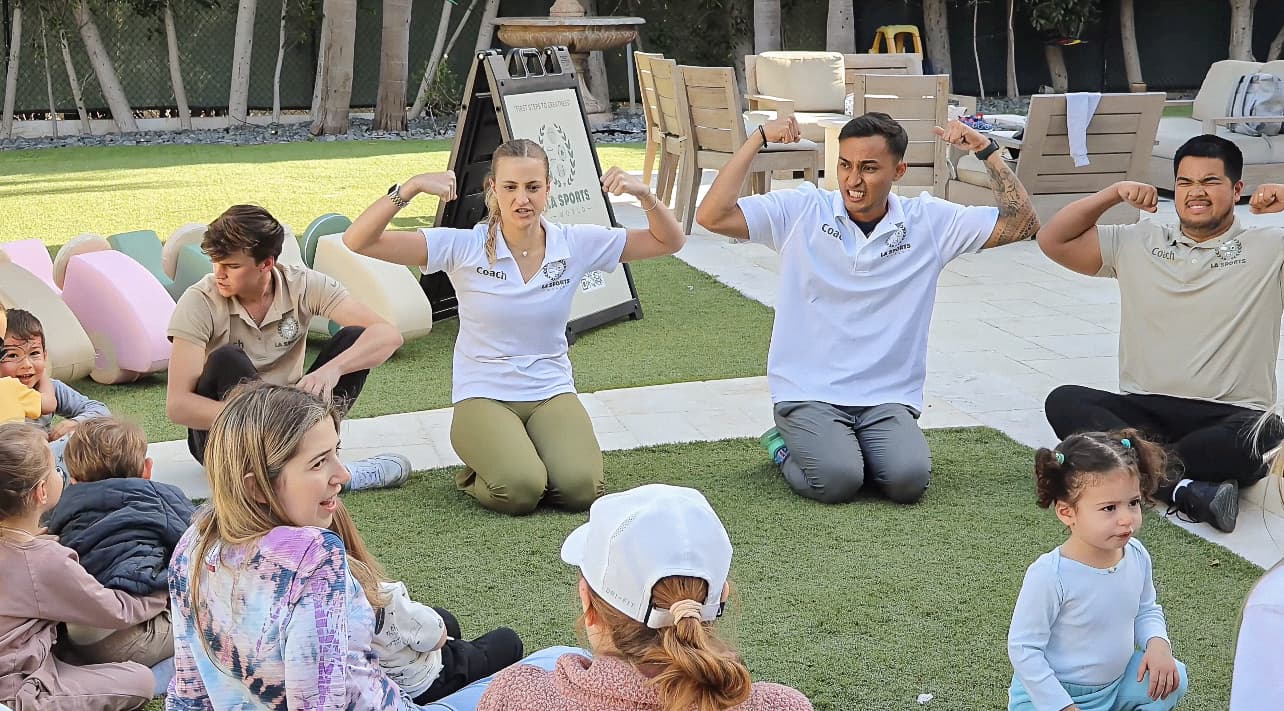 LA Sports World coaches leading a movement activity with young children