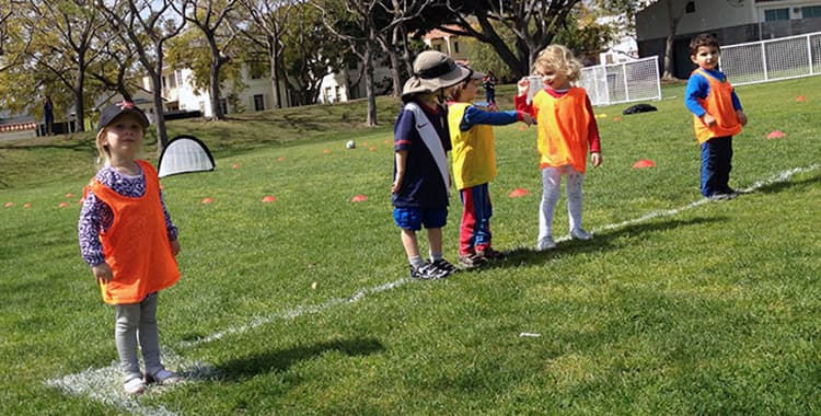 An LA Sports World coach leading children through an active group program